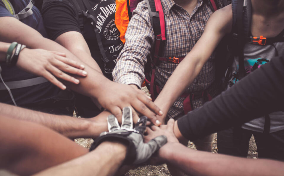Group of men joining hands
